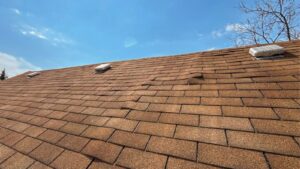 Early roof damage Mount Vernon showing missing shingles and signs of leaks on residential roof